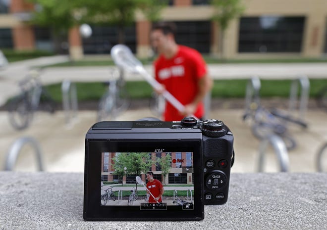 Ohio State lacrosse player Mitchell Pehlke, an aspiring YouTube personality who broadcasts a channel to 14,000 subscribers records a video for his channel outside his dorm at Ohio State on May 3, 2021.
