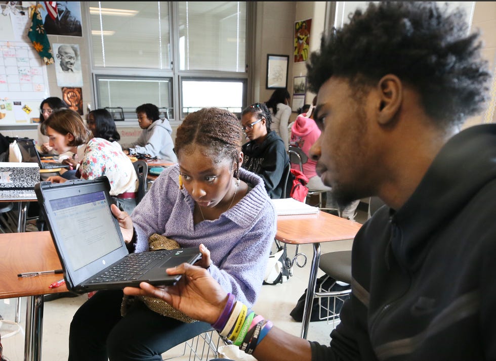 Nyjah Watson works with Johnathan White on an assignment in the AP African American Studies course at Firestone CLC, a high school in Akron, Ohio, in October.