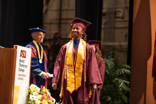 Alena McQuarter crosses the stage at Arizona State University's Barrett Honors College convocation on Monday, Dec. 11, 2023.