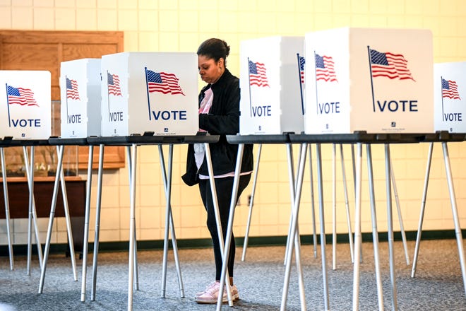 Kendra Johnson casts her vote in Michigan's primary at the new polling location at Potter Park Zoo on Feb. 27, 2024, in Lansing.