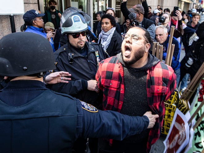 A pro-Palestinian protester is arrested outside Columbia University in Manhattan on April 22, 2024.