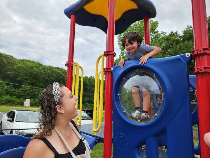 A woman and her son on a playground.