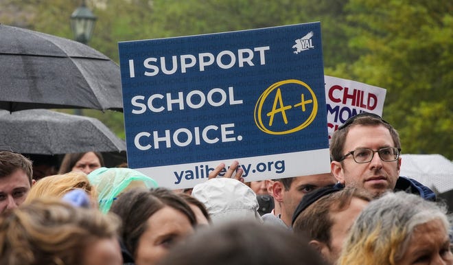 Texas Gov. Greg Abbott speaks on the steps of the state capitol to supporters at a Texas Public Policy Foundation Parent Empowerment rally on Tuesday, March 21, 2023. Abbott and his supporters have pushed for a voucher system that involves the state matching a percentage of funding for students going to private schools and another percentage to public schools.