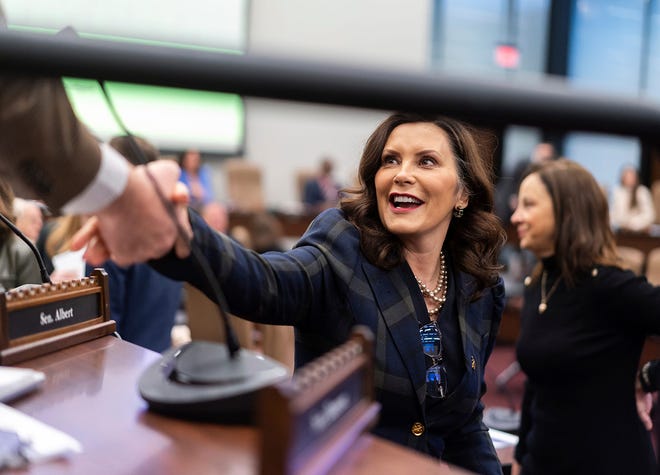 Gov. Gretchen Whitmer talks with members of the senate before delivering her budget presentation before a joint session of the state House and Senate appropriations committees at the Heritage Hall in Lansing on Wednesday, February 7, 2024. Whitmer discussed her funding priorities for the upcoming fiscal year and how she plans to pay for her proposals which are likely to include expanding state-funded preschool to all four year-olds, free community college, a vehicle tax rebate and a caregiver tax credit.