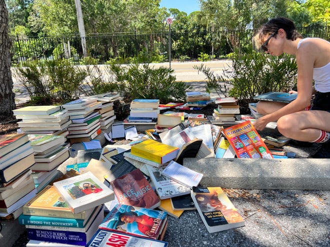 New College of Florida students, activists, and alumni sort through discarded books from the school's Gender and Diversity Center on Thursday, Aug. 15, 2024.