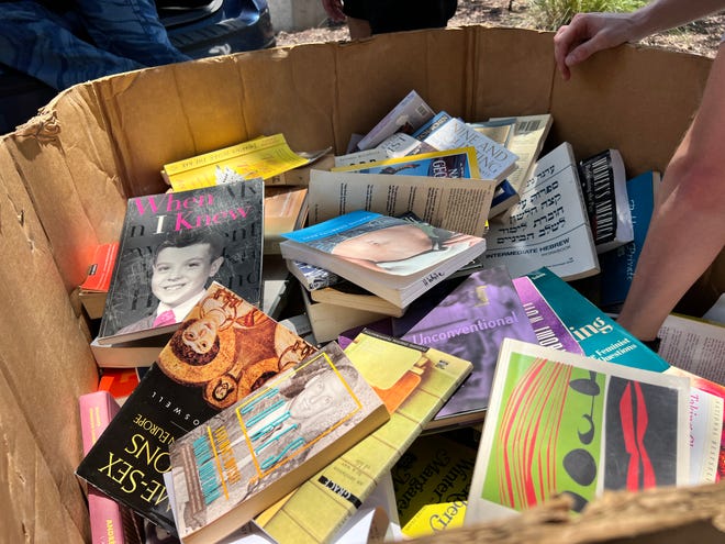 New College of Florida students, activists and alumni sift through discarded books from the school's Gender and Diversity Center on Thursday, Aug. 15, 2024.