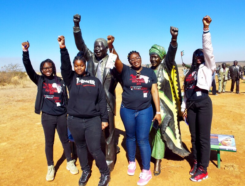 Group of high school students posing outside in front of the Long March to Freedom Memorial, Cape Town, South Africa in 2019.